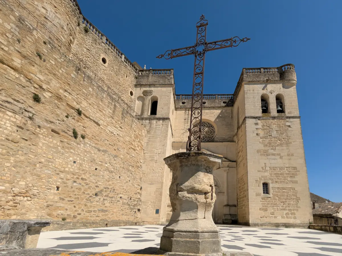 The façade and chequered forecourt of Saint-Sauveur collegiate church in Grignan