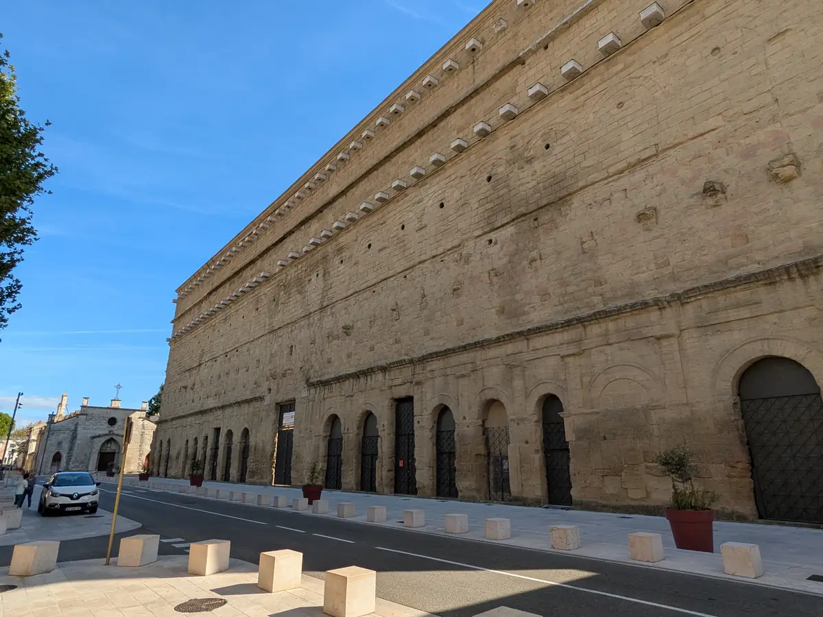 The long north façade of the ancient theatre of Orange, with doorways and rows of arches
