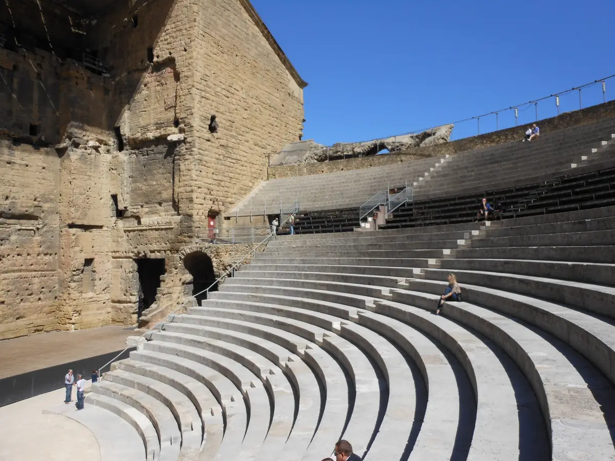 Rows of seats and stairways in the ancient theatre of Orange, seen from beside the stage