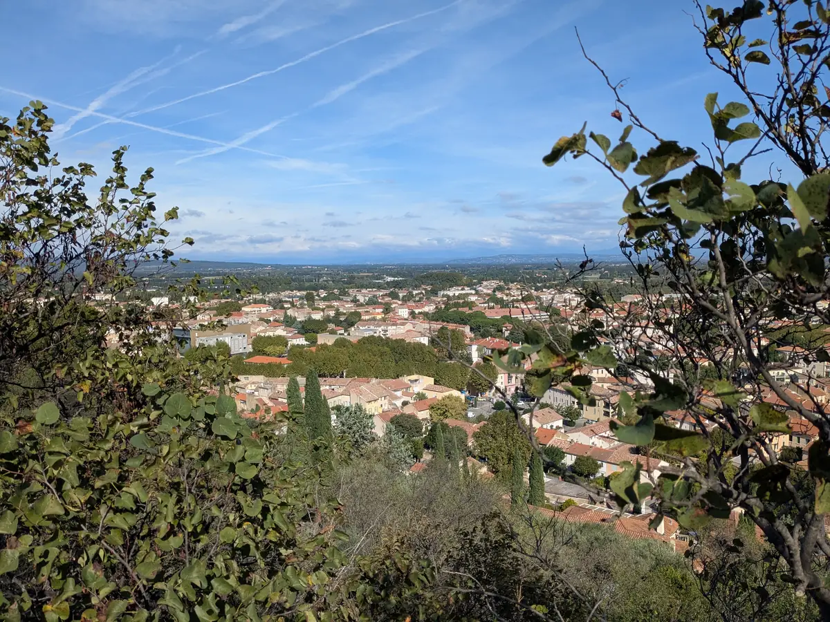 Rooftops and districts of Orange seen through the trees from Saint-Eutrope Hill