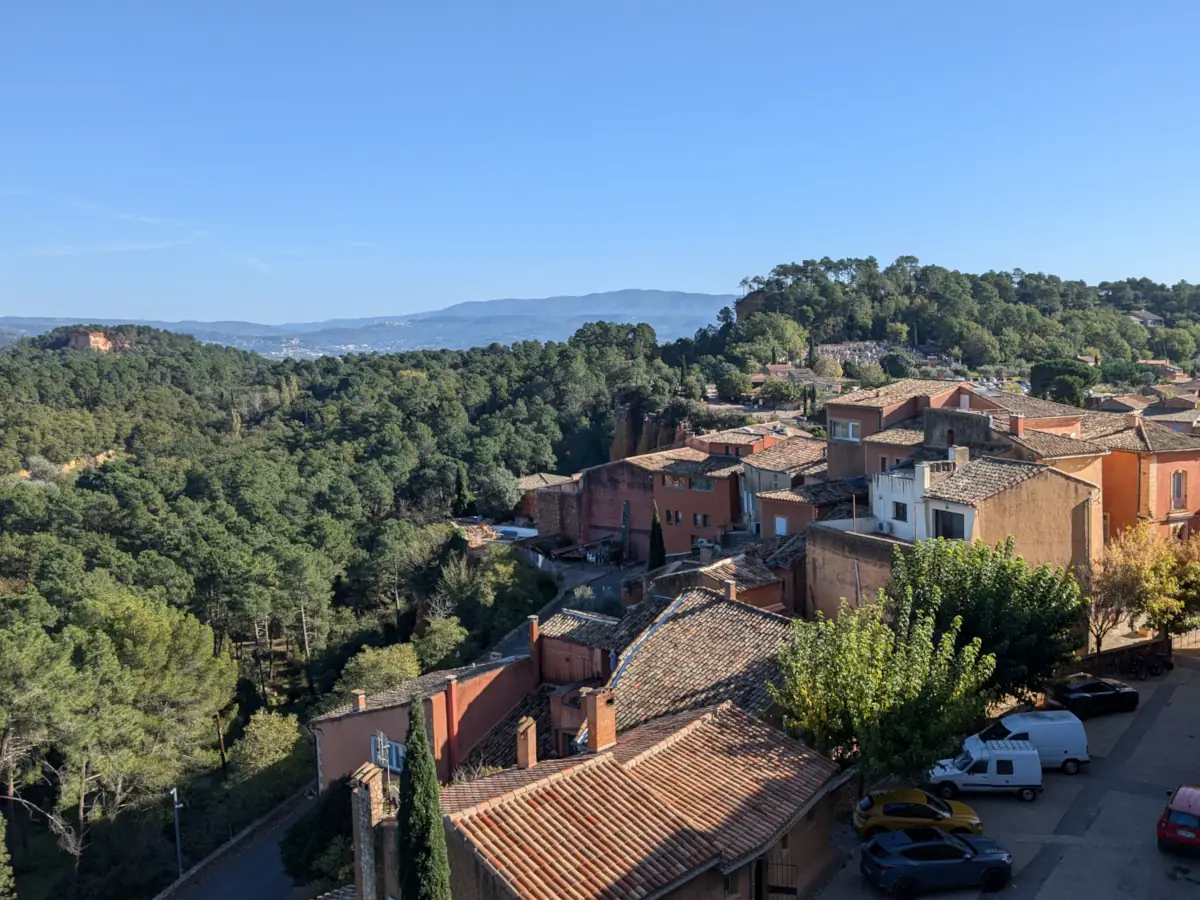 Roussillon rooftops and wooded hills seen from the top of the village